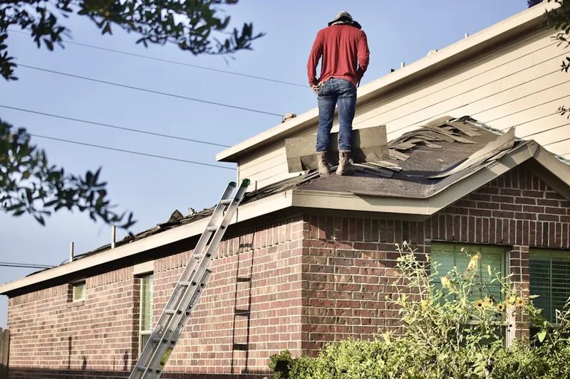 Professional roofer working on a residential roof in Port Norris